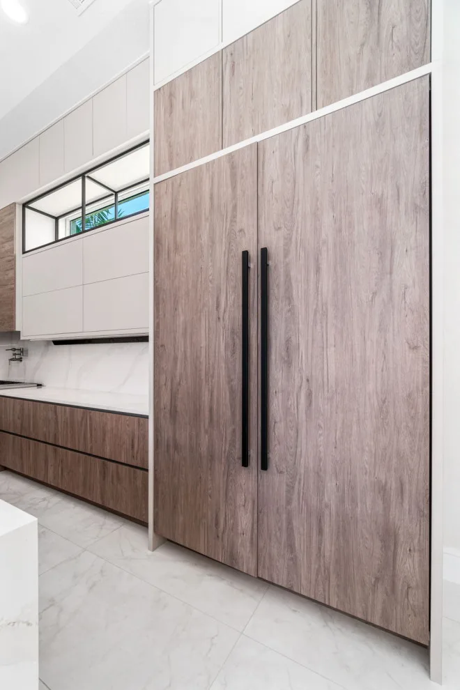 Spacious Modern Two-Tone Kitchen in West Bay by DaVinci Kitchens, Bath, & Cabinetry - Photo 24