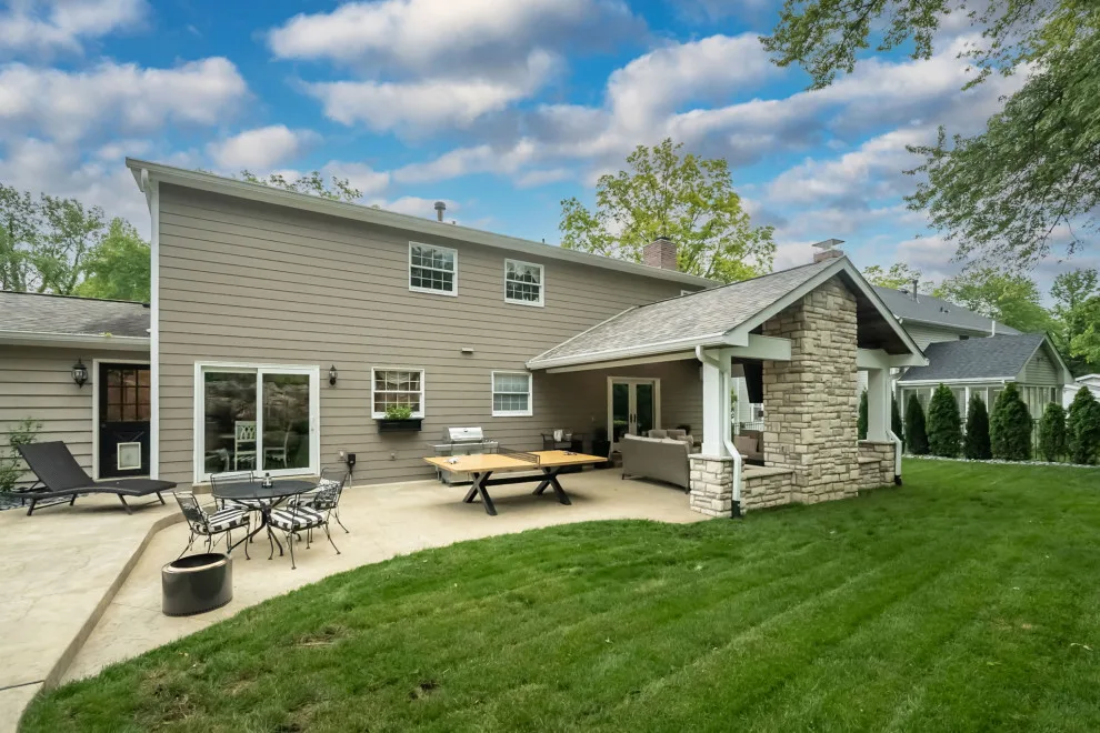 Back Patio Awning with Stone Hearth by Lakeside Renovation & Design - Photo 8