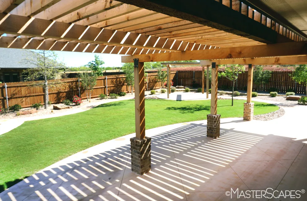 Outdoor Space with Pergola and Drought-Resistant Flowerbeds by MasterScapes - Photo 9