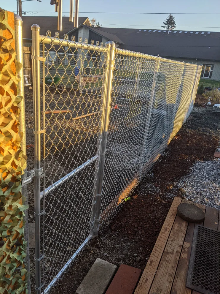 Installation of galvanized chain link fencing by All Seasons Landscaping Of Mason County LLC - Photo 4