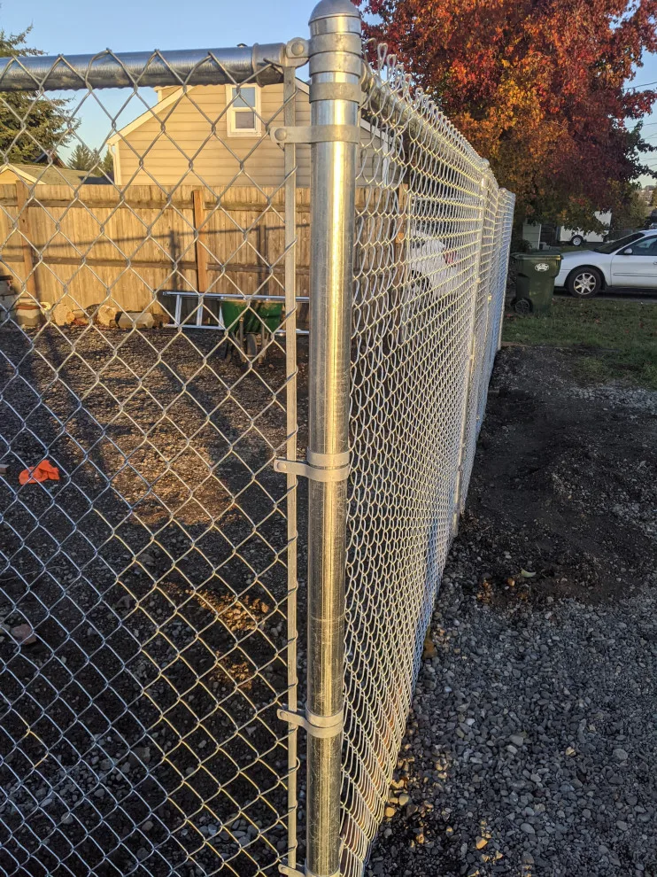 Installation of galvanized chain link fencing by All Seasons Landscaping Of Mason County LLC - Photo 5