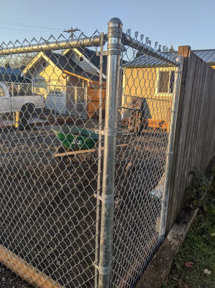 Installation of galvanized chain link fencing by All Seasons Landscaping Of Mason County LLC - Photo 6