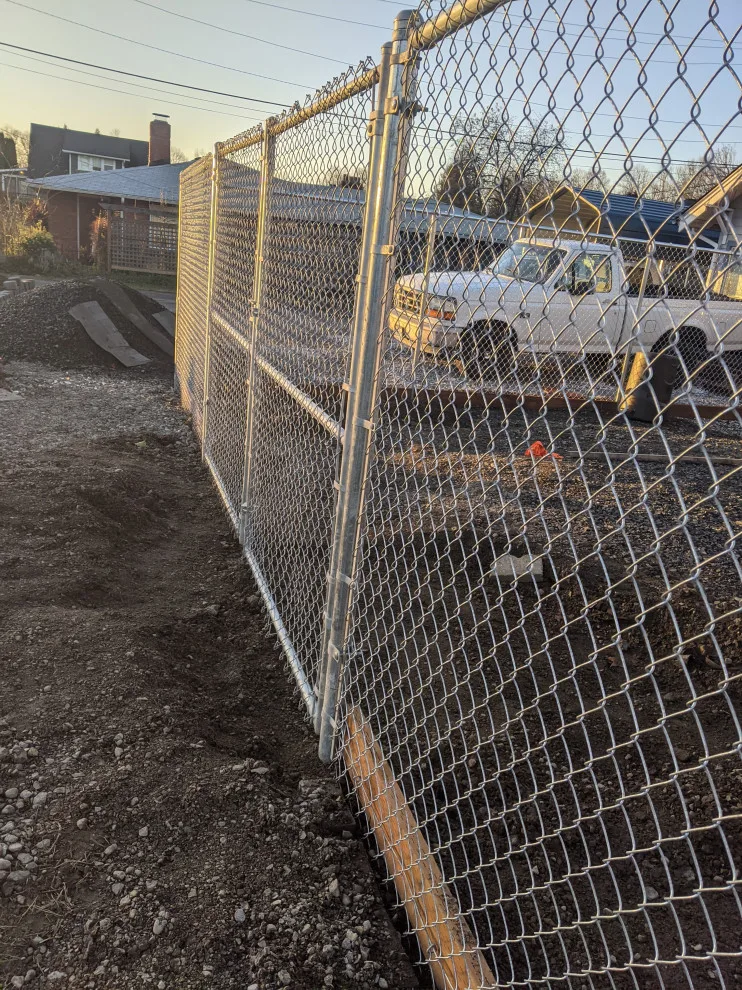 Installation of galvanized chain link fencing by All Seasons Landscaping Of Mason County LLC - Photo 2