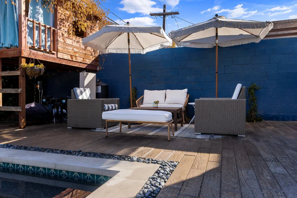 Contemporary black pebble pool and spa for a compact backyard by Vision Home Remodeling, Inc. - Photo 10