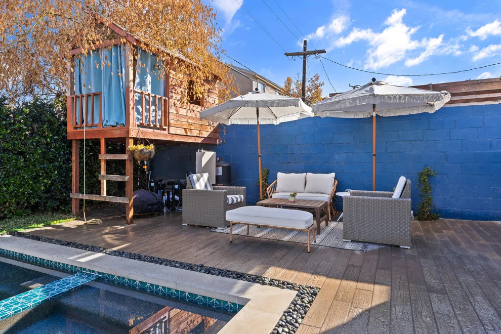 Contemporary black pebble pool and spa for a compact backyard by Vision Home Remodeling, Inc. - Photo 6