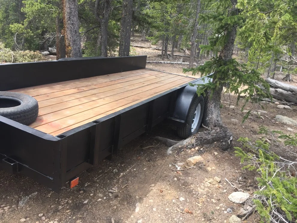 Revamped flatbed trailer with fresh paint and a custom fold-down gate by Big Horn Construction, LTD - Photo 3