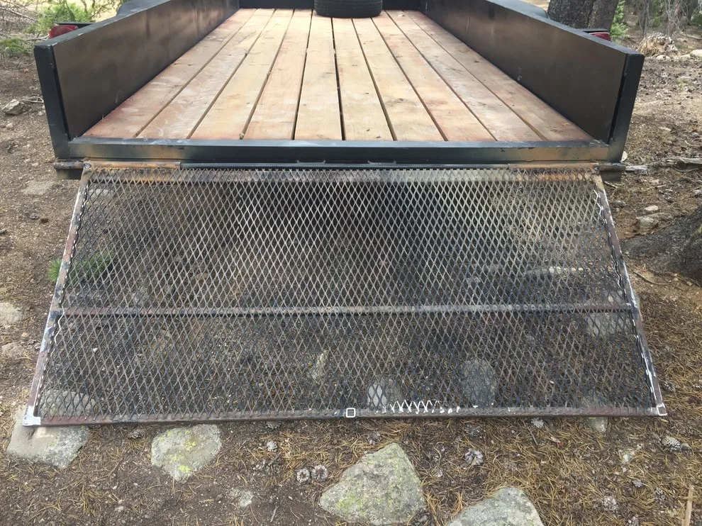 Revamped flatbed trailer with fresh paint and a custom fold-down gate by Big Horn Construction, LTD - Photo 2