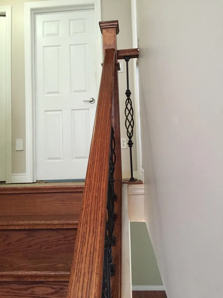 Updated staircase with handrail and wrought iron balusters by Buildby7 LLC - Photo 2
