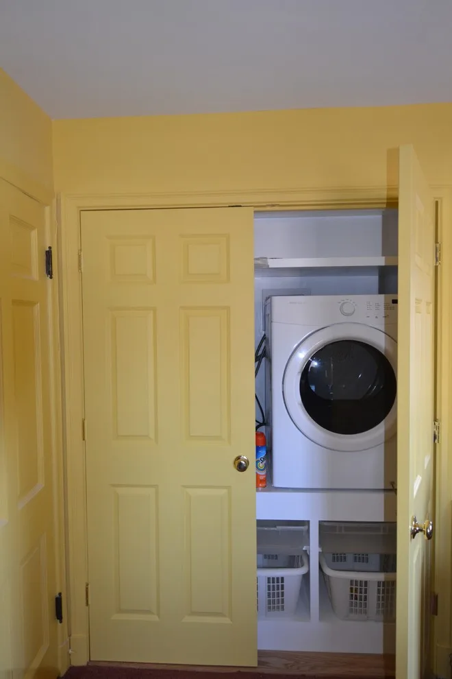 Bespoke laundry storage space by Remodeling And Painting Experts Inc. - Photo 5