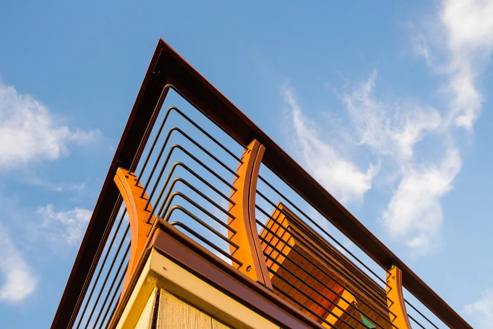 Modern deck featuring custom railings, flooring, gate, and greenhouse by Treeline Construction - Photo 6