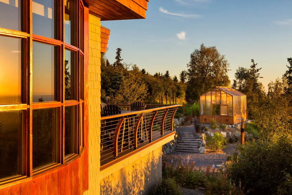 Modern deck featuring custom railings, flooring, gate, and greenhouse by Treeline Construction - Photo 51