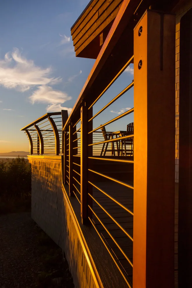 Modern deck featuring custom railings, flooring, gate, and greenhouse by Treeline Construction - Photo 16