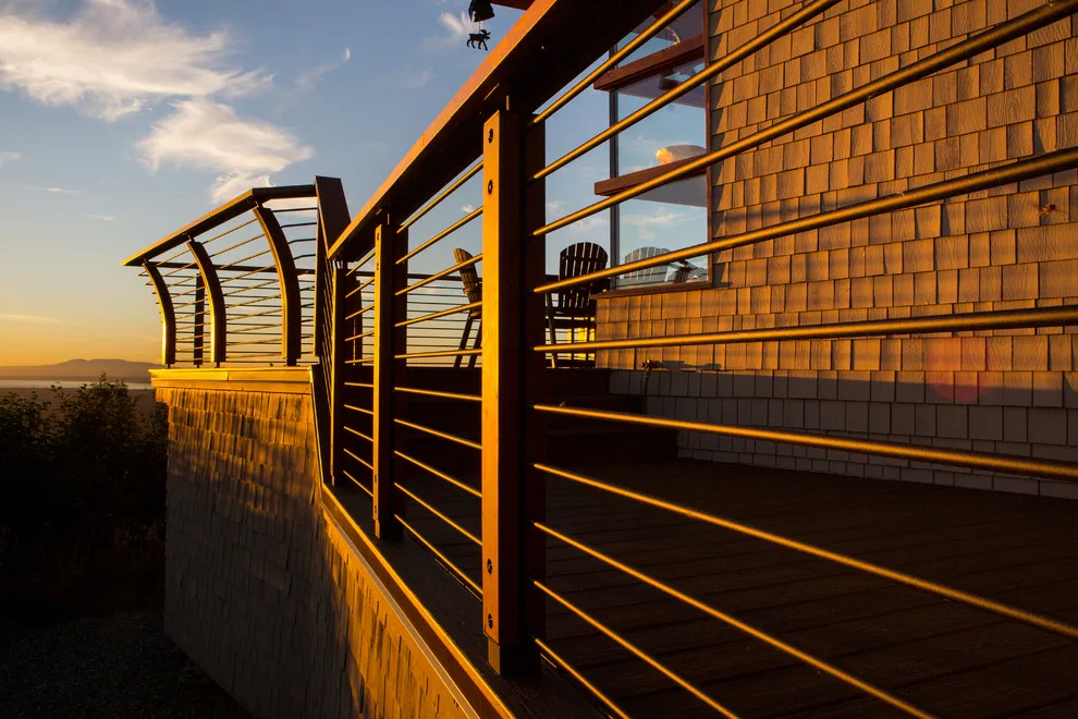 Modern deck featuring custom railings, flooring, gate, and greenhouse by Treeline Construction - Photo 15