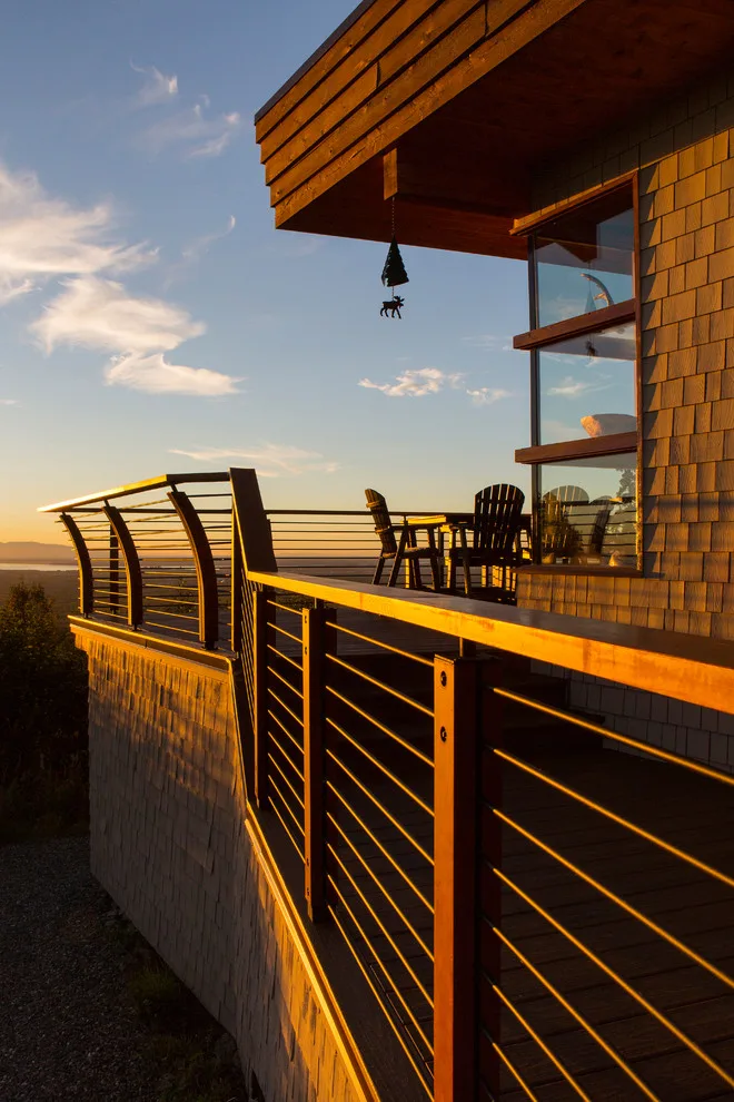 Modern deck featuring custom railings, flooring, gate, and greenhouse by Treeline Construction - Photo 53