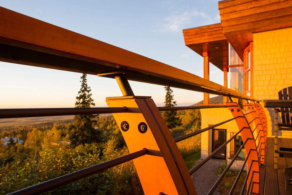 Modern deck featuring custom railings, flooring, gate, and greenhouse by Treeline Construction - Photo 14