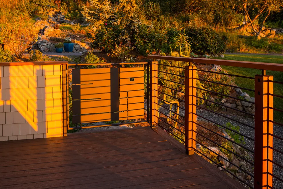 Modern deck featuring custom railings, flooring, gate, and greenhouse by Treeline Construction - Photo 29