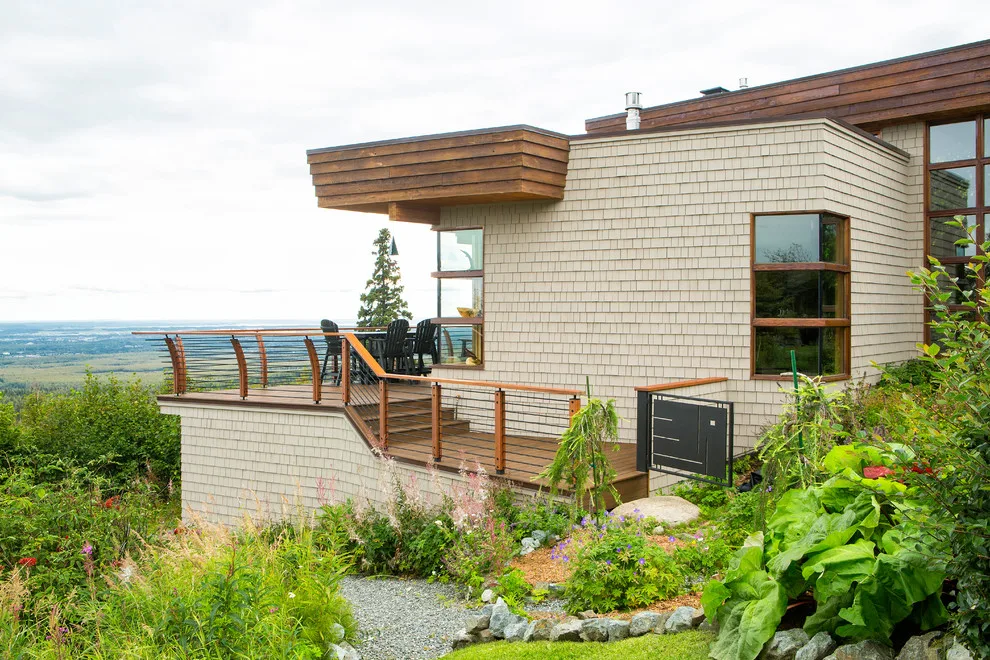 Modern deck featuring custom railings, flooring, gate, and greenhouse by Treeline Construction - Photo 30
