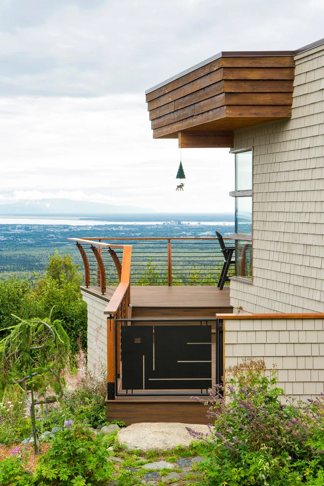 Modern deck featuring custom railings, flooring, gate, and greenhouse by Treeline Construction - Photo 33