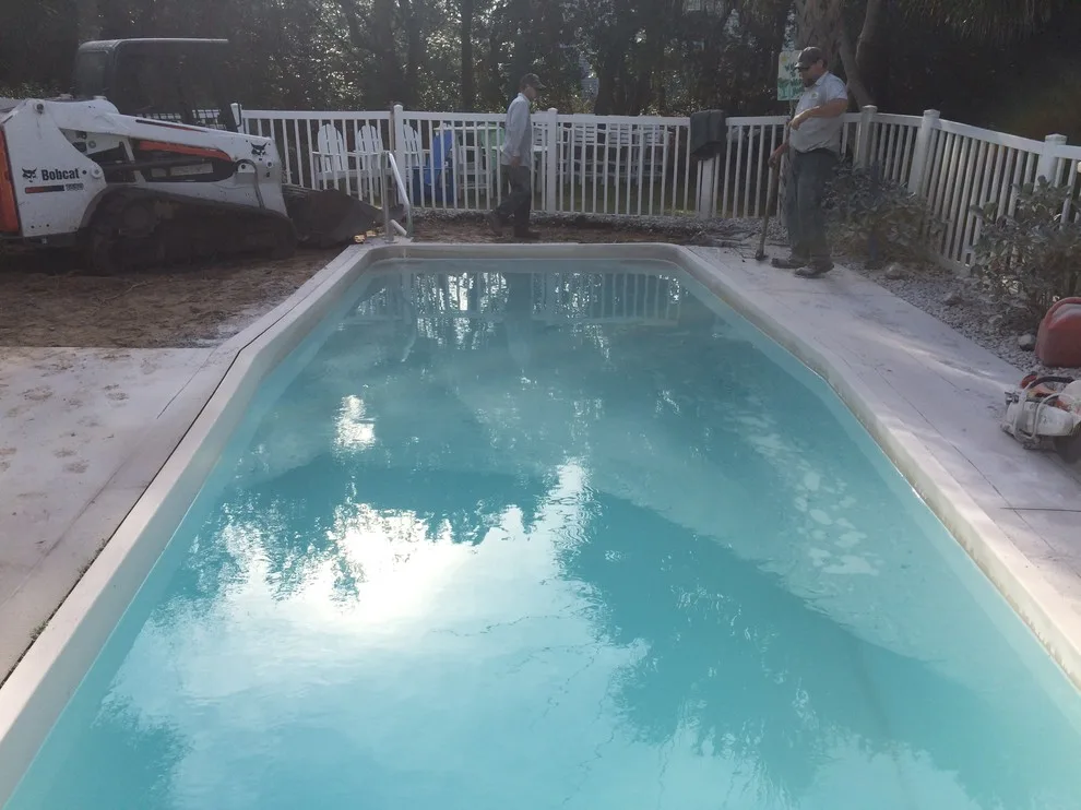 Emerald Isle pool makeover - converting old concrete deck to travertine by Yardworks, Inc. - Photo 2