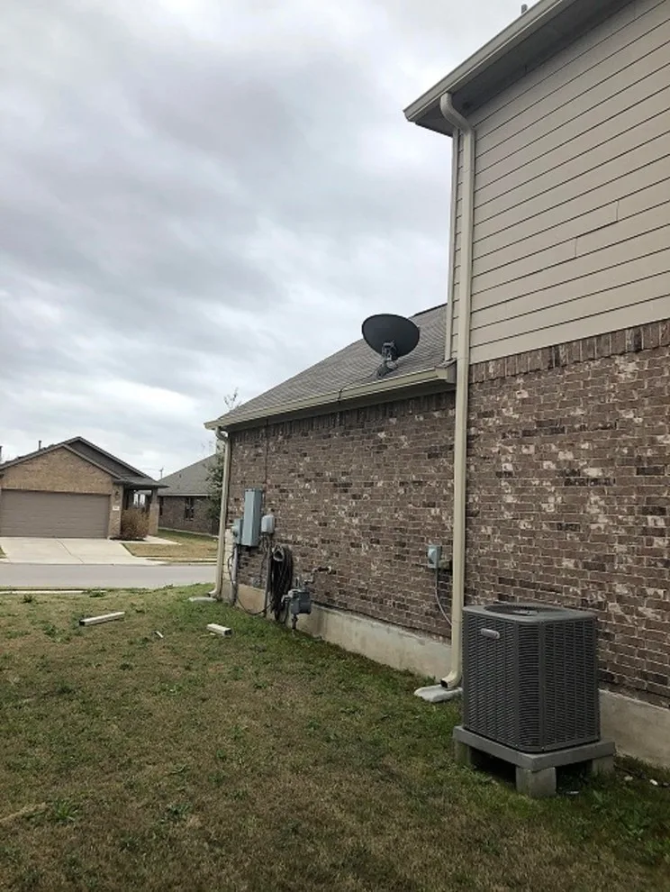 Beige Split Level Home Gutter Installation in Buda, TX by Gutter Tex - Photo 3
