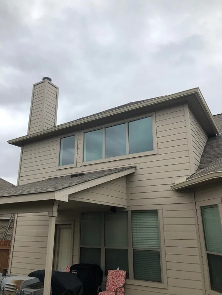 Beige Split Level Home Gutter Installation in Buda, TX by Gutter Tex - Photo 2
