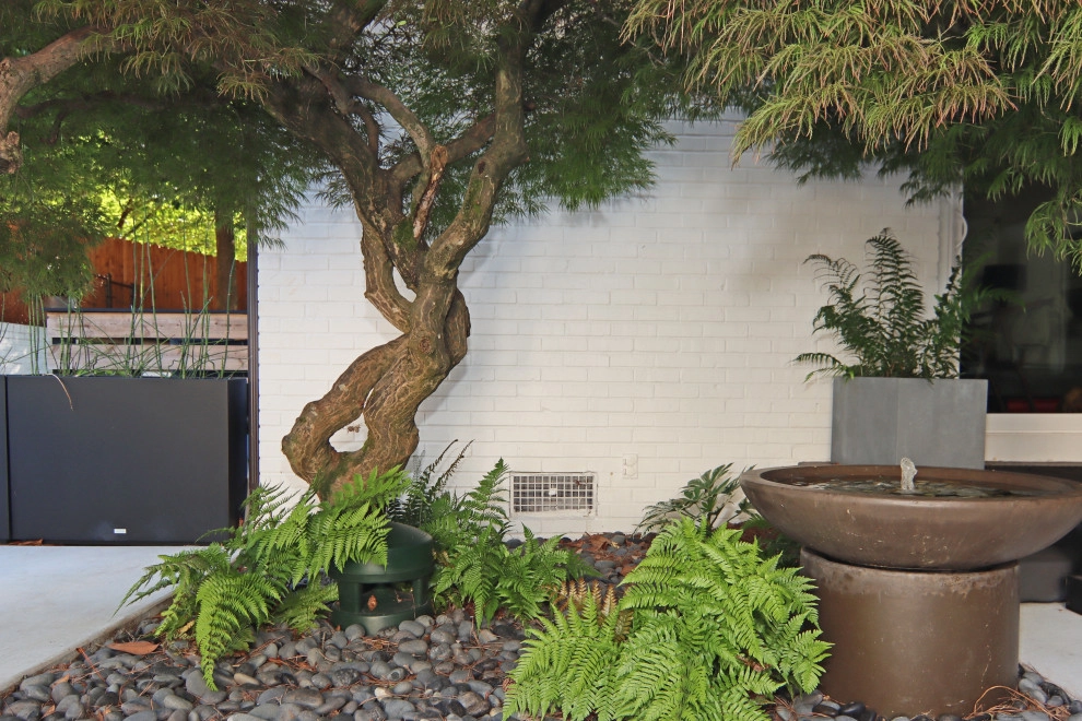 Modern patio with fireplace by City Garden Company - Photo 4