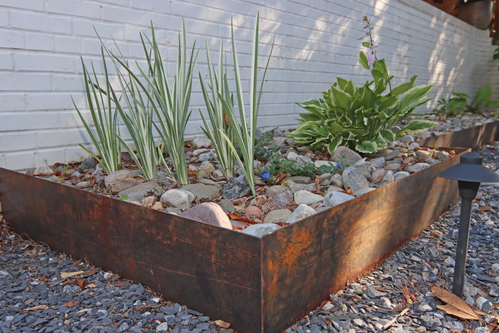 Modern patio with fireplace by City Garden Company - Photo 2