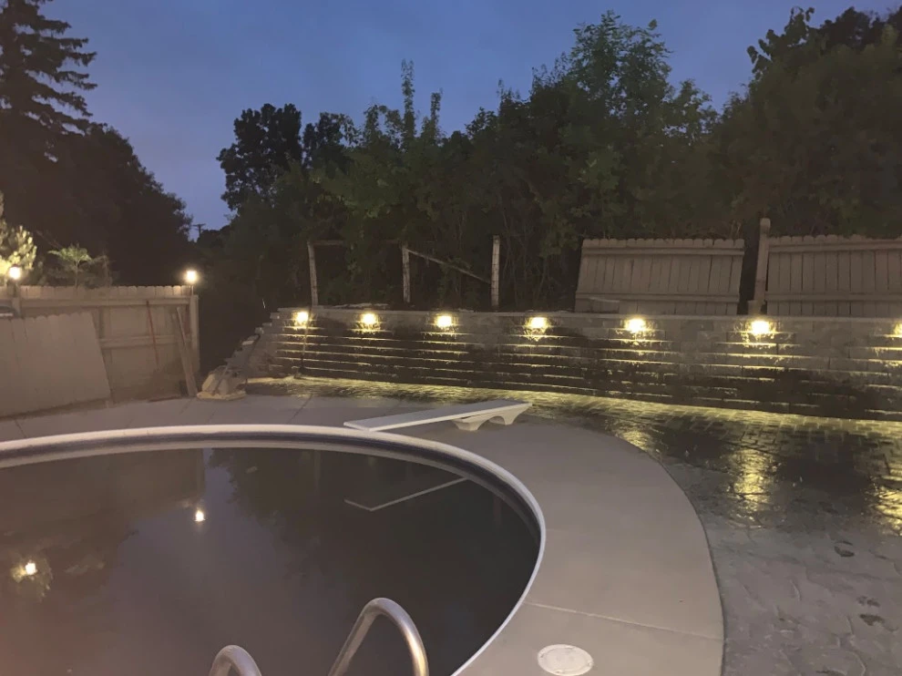 Large pool patio and wall with raised patio by South Metro Lawn And Landscape - Photo 8