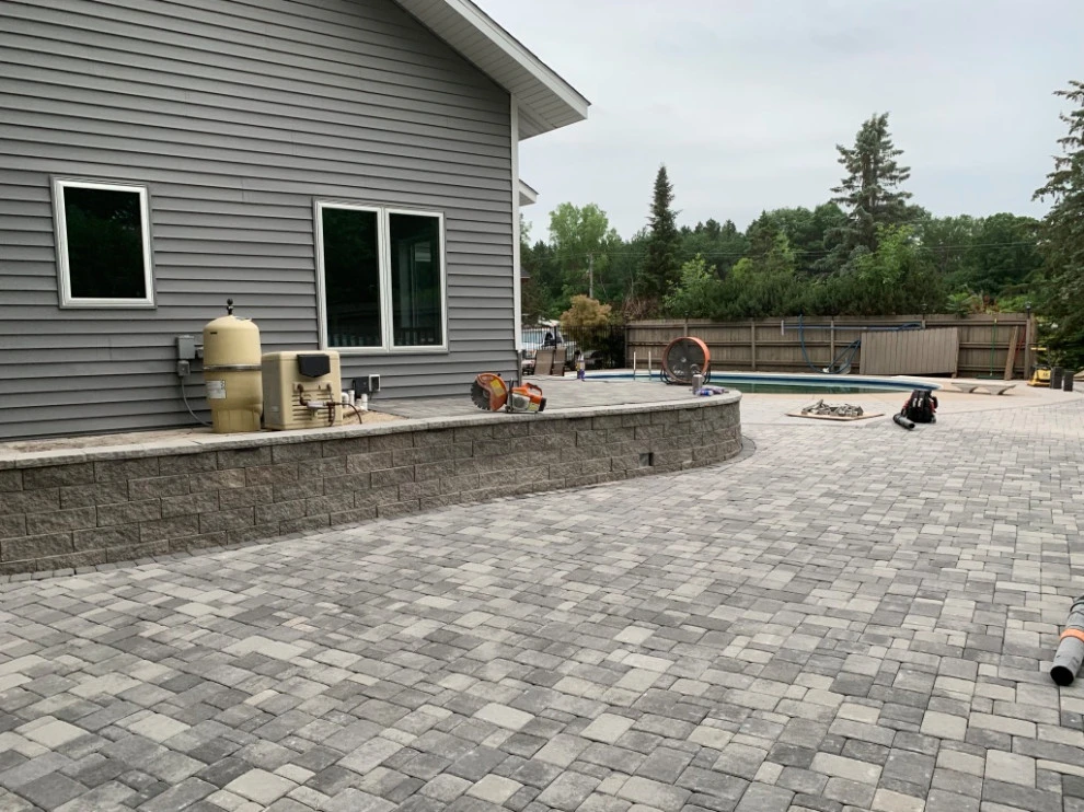 Large pool patio and wall with raised patio by South Metro Lawn And Landscape - Photo 16