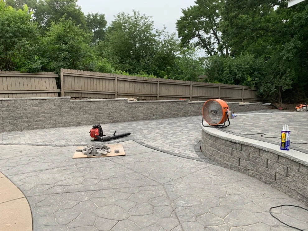 Large pool patio and wall with raised patio by South Metro Lawn And Landscape - Photo 10