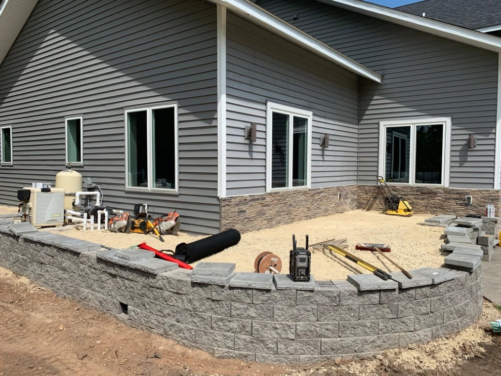 Large pool patio and wall with raised patio by South Metro Lawn And Landscape - Photo 14