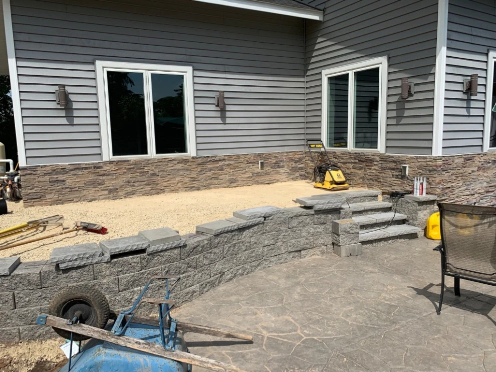 Large pool patio and wall with raised patio by South Metro Lawn And Landscape - Photo 6