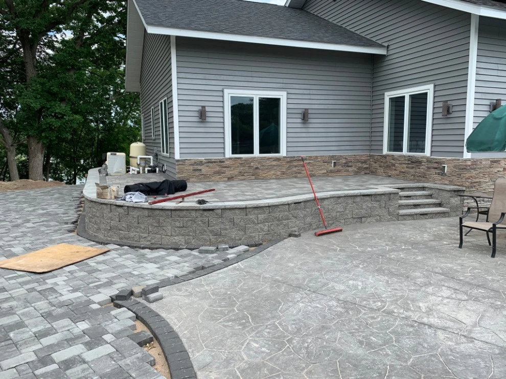 Large pool patio and wall with raised patio by South Metro Lawn And Landscape - Photo 18