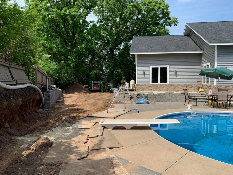 Large pool patio and wall with raised patio by South Metro Lawn And Landscape - Photo 11