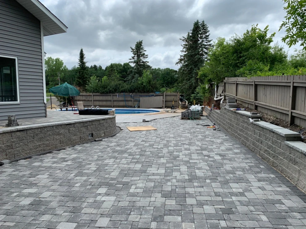 Large pool patio and wall with raised patio by South Metro Lawn And Landscape - Photo 19
