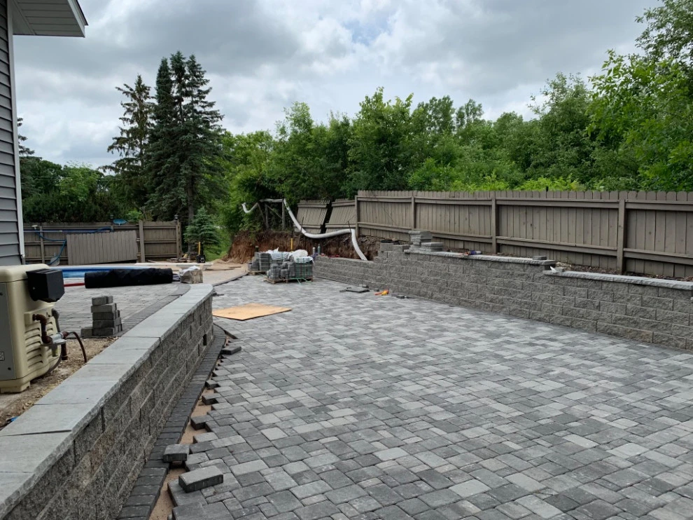 Large pool patio and wall with raised patio by South Metro Lawn And Landscape - Photo 7