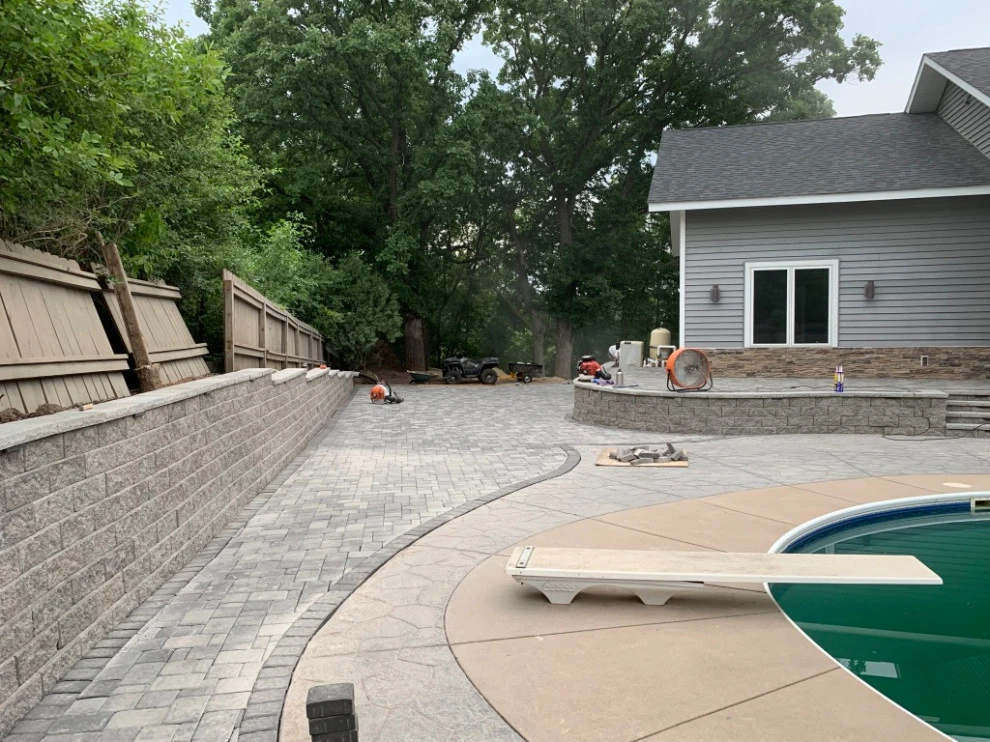 Large pool patio and wall with raised patio by South Metro Lawn And Landscape - Photo 12