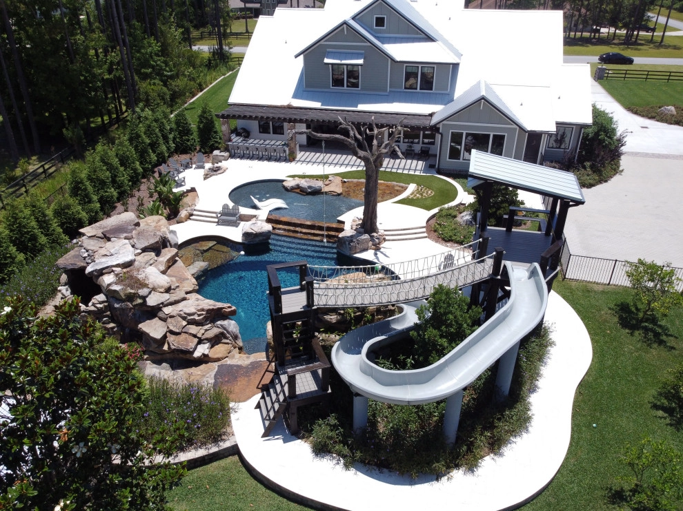 Large stone pool with grotto by Cynthia Burns Landscape Design - Photo 2