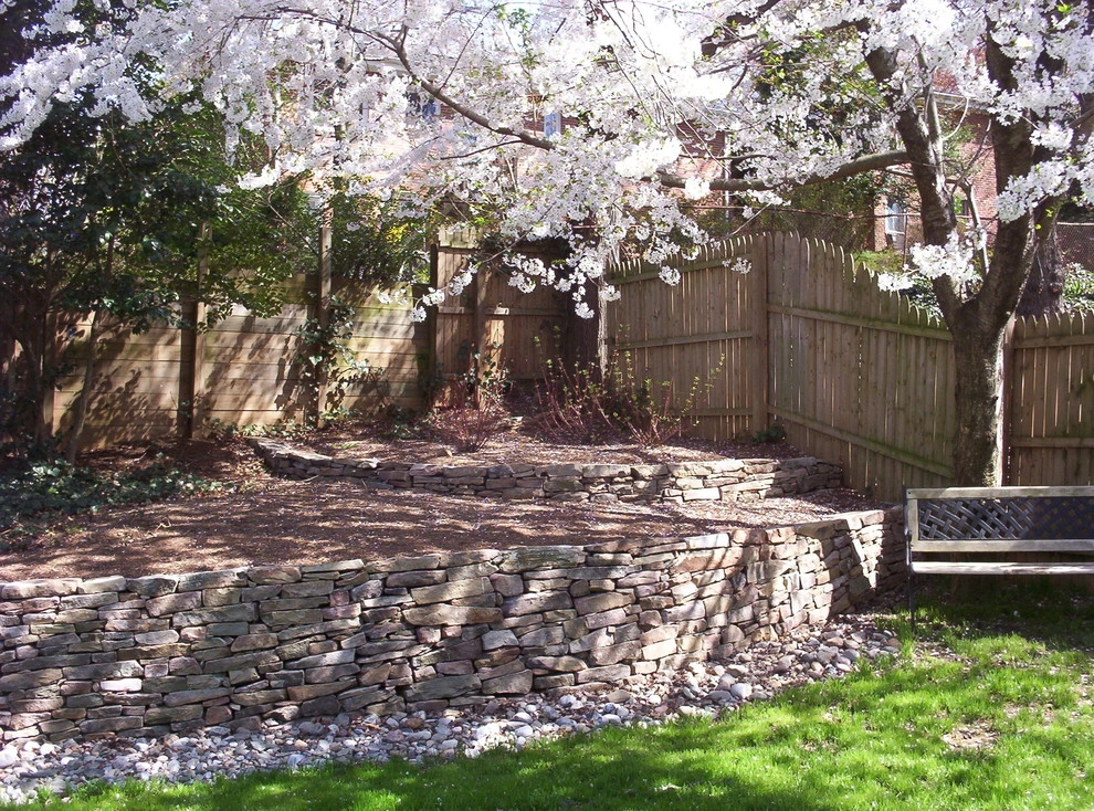 Back yard retaining wall before and after by Earth Essence Designs - Photo 2