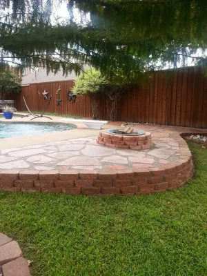 Pool hardscape expansion with fire pit by Absolutely Bushed Landscaping