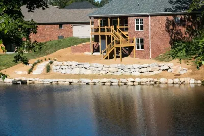 Boulder Retaining Wall, — Landscape Construction project by Lambs Lawn Service & Landscaping in Floyds Knobs