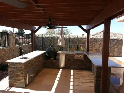 Outdoor Pergola, Kitchen, and Water Feature by Forma Contractors