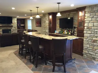 Ballwin Basement Featuring Bar and Fireplace — Home Renovation & Remodeling Services project by Pro Basement Inc.