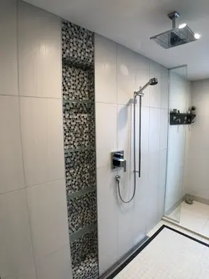 Comprehensive bathroom renovation featuring heated flooring, a walk-in shower, and additional enhancements — Home Renovation & Remodeling Services project by D & L Construction
