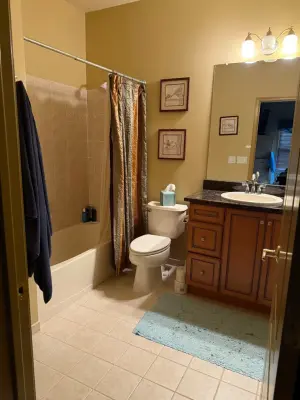 Navy Vanity with Marble Tile and Brass Accents Bathroom Makeover — Home Renovation & Remodeling Services project by Caliber Construction NJ & PA
