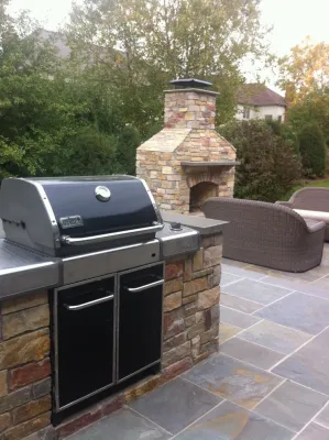 Naperville bluestone patio, outdoor kitchen, and fireplace by Hively Landscaping Inc.