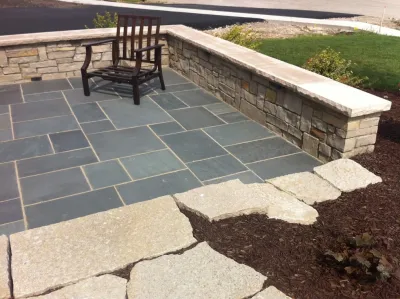 Bluestone Patio with Limestone Veneer Seat Wall by Hively Landscaping Inc.