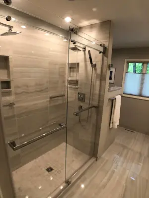 Bathroom renovation featuring a lighted mirror, heated flooring, and additional enhancements — Home Renovation & Remodeling Services project by D & L Construction