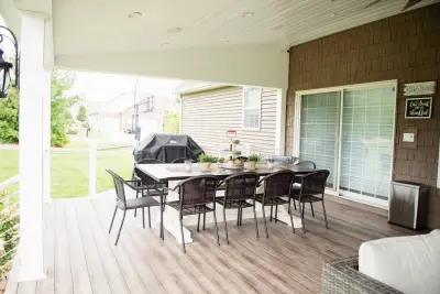 Stunning Exterior Transformation with Spacious Covered Deck and Fireplace — Home Renovation & Remodeling Services project by Cooper Construction And Restoration, Inc.