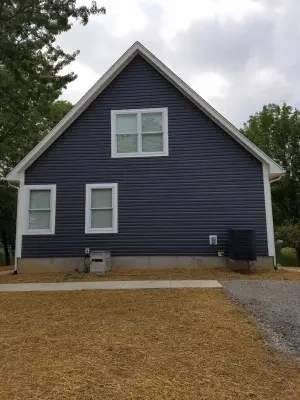 Custom Home with Blue Gable Roof by SDC Custom Homes & Remodeling
